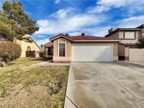 Single-story house with a two-car garage and well-maintained lawn at 6108 Autumn Rose Way, Las Vegas, NV 89142