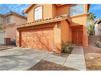 Charming two-story home featuring an attached garage, terracotta-colored facade and well-maintained landscaping at 6921 Wineberry Dr, Las Vegas, NV 89119
