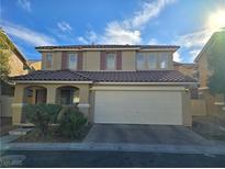 Two-story house with a two-car garage and desert landscaping at 11998 Camden Brook St, Las Vegas, NV 89183