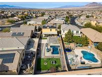 Aerial view showing home with pool, landscaped yard, and solar panels at 165 Arrow Point Ln, Henderson, NV 89011