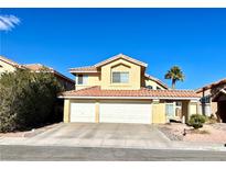 Two-story house with a three-car garage and desert landscaping at 1764 Sunflower Ct, Henderson, NV 89074