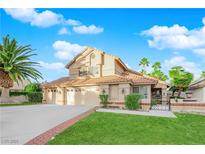 Two-story house with a two-car garage and landscaped front yard at 1968 Revere Ct, Henderson, NV 89014