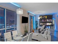 Bright living room with city views, features a large screen and comfortable seating at 200 W Sahara Ave # 1012, Las Vegas, NV 89102