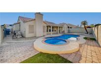 Inviting backyard oasis featuring a sparkling pool and spa at 2214 Sexton Ave, North Las Vegas, NV 89031