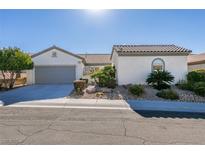 Single-story home with gray garage door and landscaped yard at 2429 Anderson Park Dr, Henderson, NV 89044