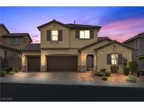 Two-story house with brown doors and shutters, a paved driveway, and landscaping at 2571 Hazelburn Ave, Henderson, NV 89044