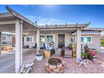 Cozy front yard with covered patio, fire pit, and mature landscaping at 309 Wisteria Ave, Las Vegas, NV 89107