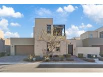 Modern two-story home with stone accents and a pergola at 4302 Swift St, Las Vegas, NV 89135