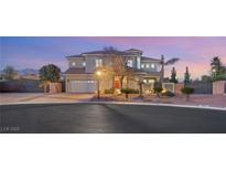 Two-story house with red door, landscaping, and gated entrance at 6004 Chessington Ave, Las Vegas, NV 89131