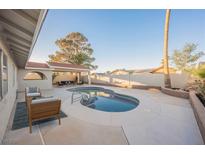 Inviting backyard oasis featuring a sparkling pool, patio furniture, and a covered seating area at 6750 Laronda Ln, Las Vegas, NV 89156