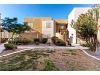 Tan two-story building with landscaping and walkways at 6885 Tamarus St # 201, Las Vegas, NV 89119