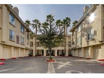 Community courtyard with palm trees and building exterior at 7119 S Durango Dr # 107, Las Vegas, NV 89113