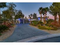 Luxury home with a large driveway, mature landscaping, and three-car garage at 7436 Oak Grove Ave, Las Vegas, NV 89117