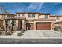 Two-story house with brown garage doors and landscaping at 7700 Tierra Montanosa Ave, Las Vegas, NV 89179