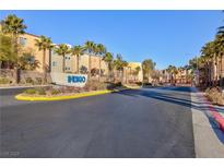 Indigo community entrance with palm trees and building view at 9378 Hilgard Ave, Las Vegas, NV 89178