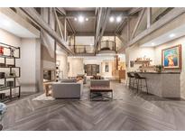 Spacious living room with high ceilings, exposed beams, and a fireplace at 10 Wild Dunes Ct, Las Vegas, NV 89113
