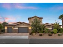 Two-story house with gray siding, three-car garage, and landscaping at 286 Chartan Ave, Las Vegas, NV 89183