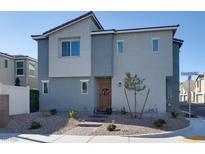 Two-story house with gray siding, landscaped yard, and a walkway leading to the front door at 2905 Bahama Yellow Ave, North Las Vegas, NV 89086