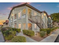 Two-story building with multiple units, featuring a walkway and landscaping at 3540 Cactus Shadow St # 201, Las Vegas, NV 89129