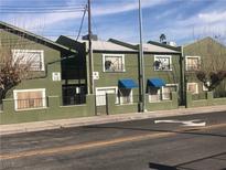 Green apartment building with multiple units and street parking at 520 S 13Th St # D25, Las Vegas, NV 89101