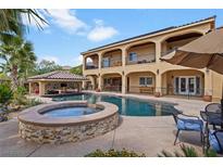 Resort-style backyard oasis with a large pool, spa, and covered patio at 5805 Cabo San Lucas Ave, Las Vegas, NV 89131