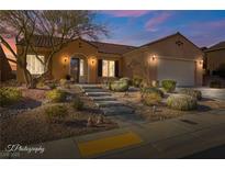 Beautiful desert landscaping surrounds this one-story home with a Spanish-style facade at 993 Starlight Terrace Way, Mesquite, NV 89034