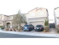 Two-story house with attached garage and landscaped yard at 1550 Visible Ave, North Las Vegas, NV 89031