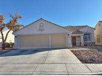 One-story house with three-car garage and desert landscaping at 3760 Yorba Linda Dr, Las Vegas, NV 89122