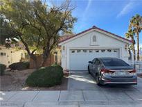 Single-story home with attached garage and mature landscaping at 5655 White Dune St, Las Vegas, NV 89113