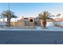 Single-story house with a tile roof, two-car garage, and landscaped yard at 8032 Deep Stone Ave, Las Vegas, NV 89149