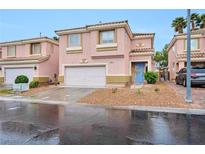 Charming two-story home featuring a blue front door and a well-maintained, low maintenance landscaped yard at 9247 Tulip Trestle Ave, Las Vegas, NV 89148