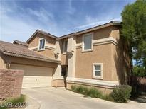 Two-story house with attached garage and landscaping at 1434 Summer Glow Ave, Henderson, NV 89012