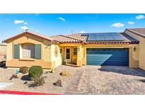 Single-story home with solar panels, desert landscaping, and a paved driveway at 2225 Chandler Ranch Pl, Laughlin, NV 89029