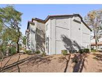 Exterior view of a multi-story building with simple landscaping and mature trees at 2615 W Gary Ave # 2040, Las Vegas, NV 89123