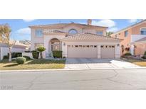 Two-story house with a three-car garage and manicured lawn at 31 Castle Creek Ct, Las Vegas, NV 89148