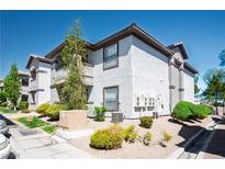 Condominium exterior showing well-maintained landscaping with gravel, shrubbery, and a view of the building's facade at 45 Maleena Mesa St # 223, Henderson, NV 89074