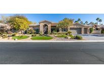 Beautiful home exterior with lush landscaping and a welcoming front entrance at 4702 Blue Mesa Way, Las Vegas, NV 89129