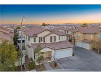 Two-story house with tile roof, two-car garage, and desert landscaping at 6005 Bristol Crest Ln, Las Vegas, NV 89139