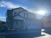 Two-story house with attached garage and landscaping at 6005 Bristol Crest Ln, Las Vegas, NV 89139