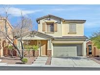 Two story house with attached garage and stone accents at 6554 Macdoogle St, Las Vegas, NV 89166