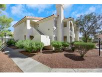 Attractive condo building with landscaping and walkway at 7905 Lago Vista Ln # 201, Las Vegas, NV 89145