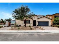 Single-story house with gray garage door, RV parking, and landscaped yard at 8811 Pauley Hills St, Las Vegas, NV 89131