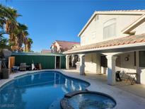 Home with a sparkling pool, spa, and covered patio at 1526 Carriagedale Ct, Las Vegas, NV 89110