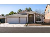 Single-story house with a three-car garage and desert landscaping at 1781 Lakewood Dr, Henderson, NV 89012