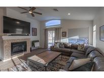 Spacious living room with fireplace and large sectional sofa at 2044 Glorieta Ln, Las Vegas, NV 89134