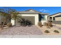 Single-story house with brown garage door and landscaped front yard at 2254 Cold Canyon Ave, North Las Vegas, NV 89086