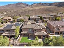 Sprawling home featuring a vibrant lawn and stylish tile roofing, set against a picturesque mountain backdrop at 2717 Mona Lisa St, Henderson, NV 89044