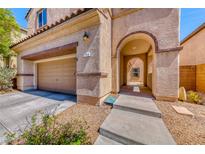 Two-story house with arched entryway and attached garage at 2744 Drummossie, Las Vegas, NV 89044