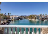 Gorgeous waterfront view of the homes and boats along a canal, with mountains in the distance at 3173 Lido Isle Ct, Las Vegas, NV 89117