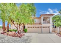 Two-story house with three-car garage and landscaped yard at 3380 Shallow Pond Dr, Las Vegas, NV 89117